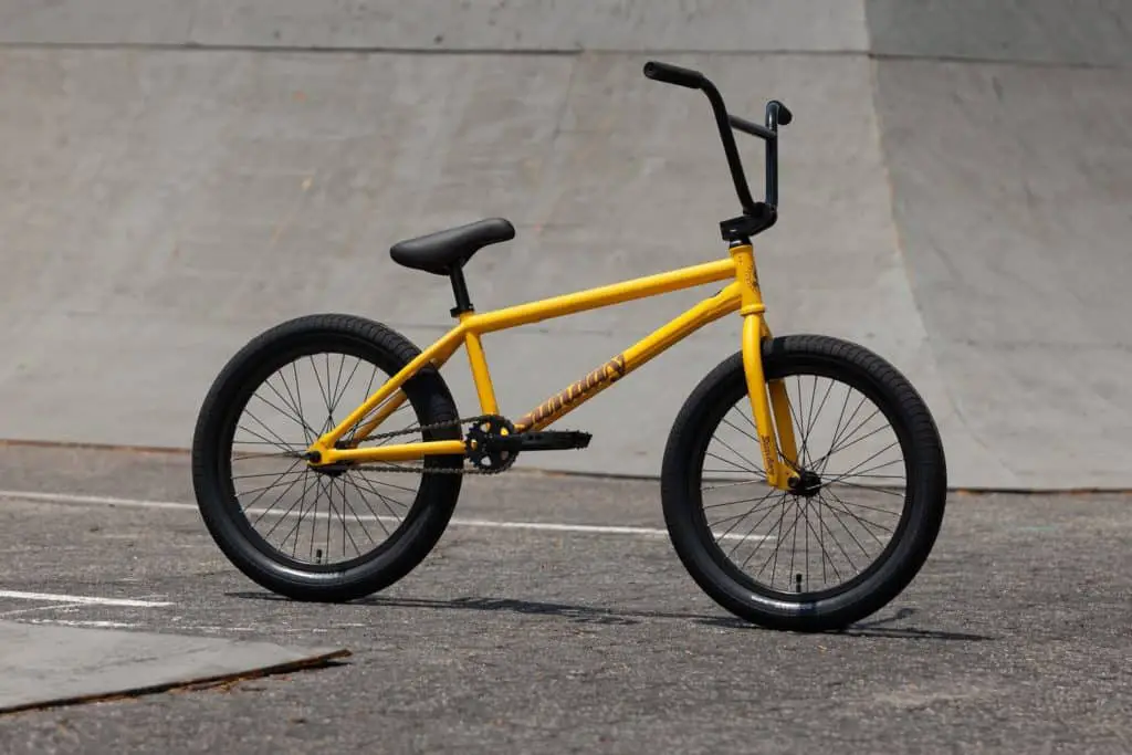 2022 Sunday EX bmx bike in mustard yellow color outside at a skatepark